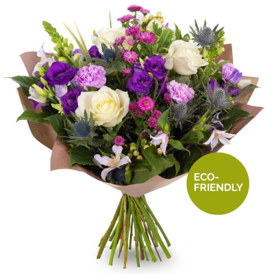 Amethyst Charm - A striking hand-tied bouquet featuring a beautiful blend of rich violet, soft lavender, crisp white, and vibrant pink tones. Carefully arranged with seasonal blooms and textured foliage, this elegant design offers a wonderful balance of colour, depth, and natural beauty. Wrapped in stylish kraft paper for a contemporary finish, it makes a thoughtful gift for birthdays, anniversaries, thank-you gestures, or any special occasion.