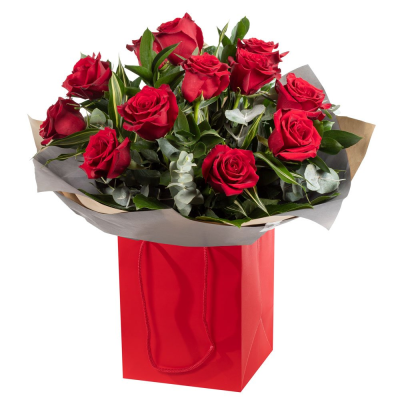 12 Red Roses - 12 Red Roses beautifully arranged with lush greenery for a classic and sophisticated look. Expertly hand-crafted and elegantly wrapped, this striking design is the perfect way to express love, admiration, gratitude, or heartfelt sentiments. Presented in a stylish gift bag, it creates an unforgettable impression for any special occasion.