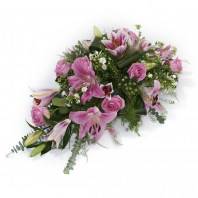 Pink Remembrance Spray - A graceful single-ended funeral spray designed to express love, sympathy, and heartfelt remembrance. Featuring soft pink tones complemented by delicate white accents and lush greenery, this elegant tribute offers a gentle and comforting way to honour the memory of a loved one.

Carefully handcrafted by a professional florist, this traditional funeral arrangement is suitable for placement beside the coffin or as a meaningful floral tribute at funeral services and memorial gatherings. Its soft, flowing design conveys warmth, affection, and lasting memories.
