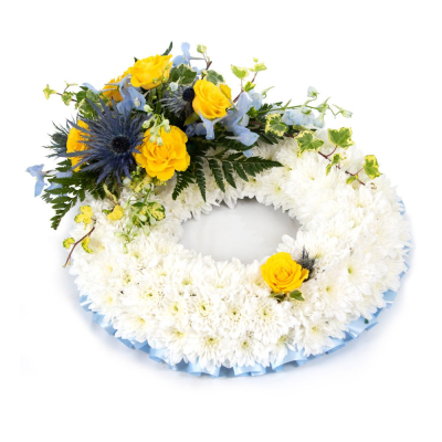 Massed Wreath - A beautiful funeral wreath designed to celebrate a cherished life and honour treasured memories. Featuring a peaceful base of soft white tones accented with vibrant golden yellow and gentle blue hues, this elegant circular tribute symbolises remembrance, hope, and everlasting love.

Expertly handcrafted by a professional florist, this wreath combines soothing colours and natural textures to create a meaningful expression of sympathy. Suitable for funeral services, memorial ceremonies, and celebrations of life, it offers a heartfelt way to pay tribute while providing comfort to family and friends.